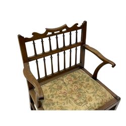 Late 18th century walnut 'Drunkard's' chair, the shaped cresting rail over spindle back, wide set seat with upholstered drop in cushion, shaped arms with scroll carved terminals, sledge supports with bracket feet joined by plain stretchers 