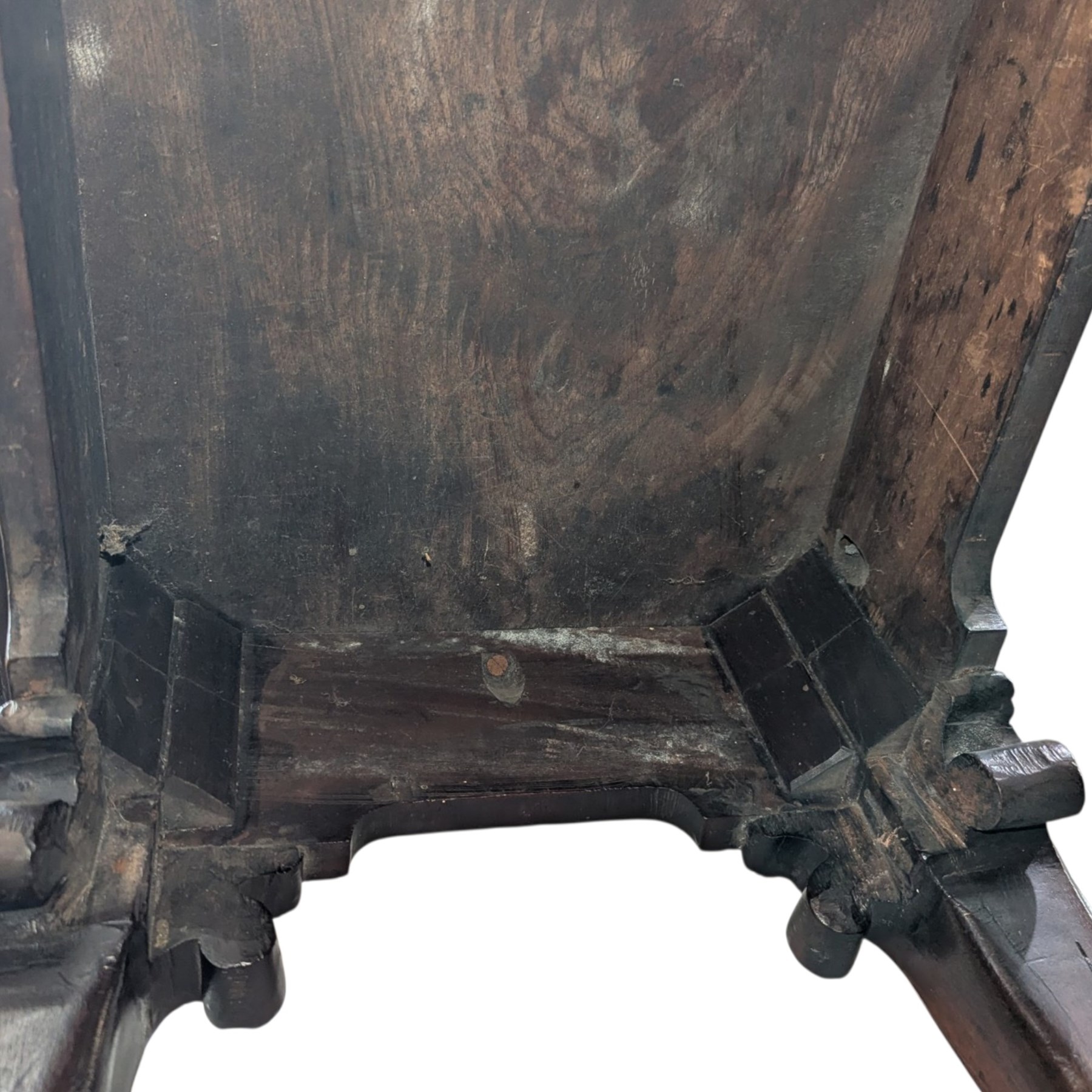 George I carved mahogany side table, adapted from a card table, the rectangular top with foliate-carved edge above a plain frieze, raised on cabriole legs with acanthus-carved knees, volute brackets and floral-carved motifs, terminating to ball-and-claw feet
