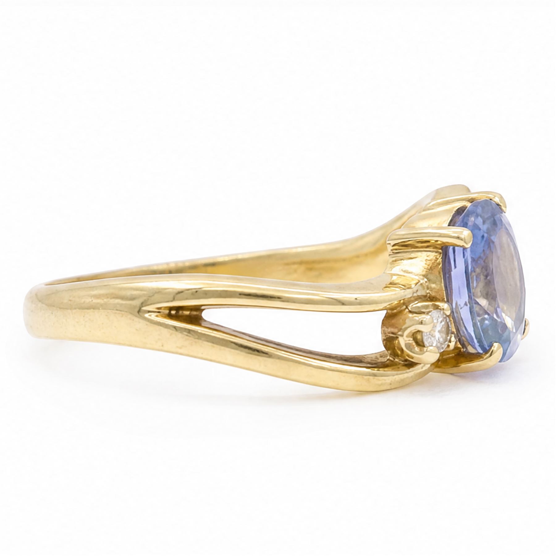 18ct gold sapphire and diamond three stone crossover ring, single oval cut sapphire of approx 1.15 carat, with a single cut diamond set either side, Birmingham 1991