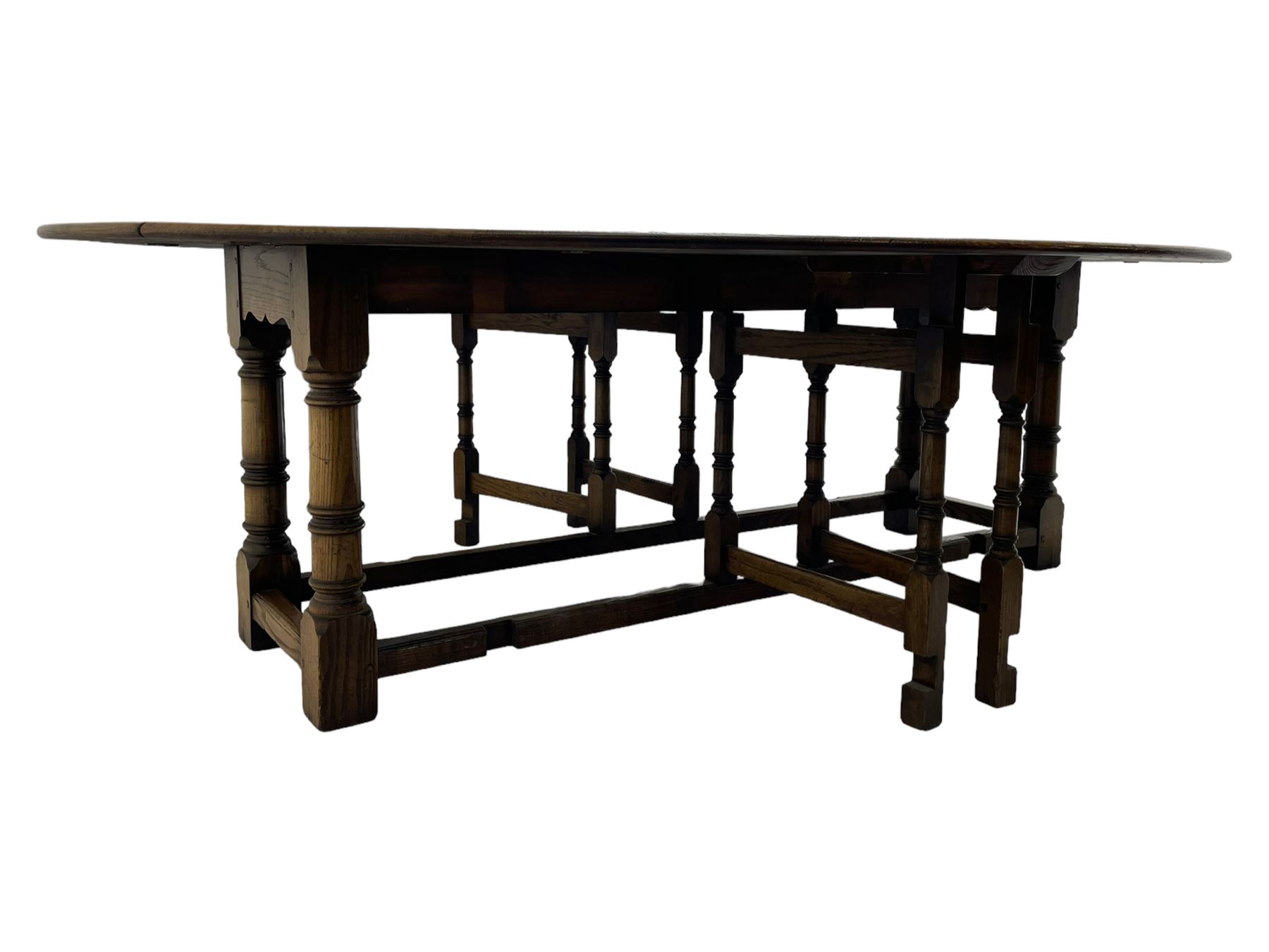 Large 18th century design oak wake or dining table, oval drop-leaf top, turned supports with double gate-leg action base, united by moulded stretchers 