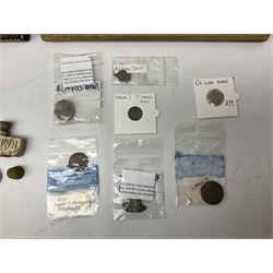 Collection of metal detecting finds, most contained within display frames and labelled, some loose, to include musket balls, bill hook, axe fragment, hubcaps, shell cases, regimental badges, coins, etc. 