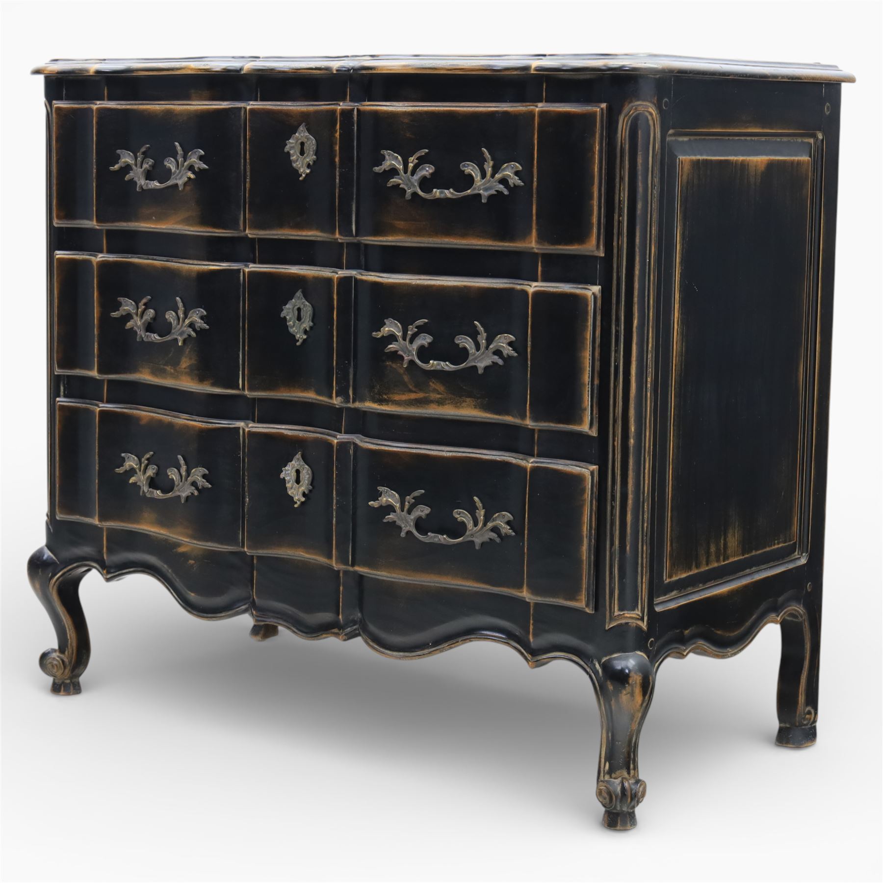 French style black lacquered chest of drawers, the serpentine front fitted with three graduated drawers mounted with scrolling foliate metal handles and key plates, shaped apron and scrolled cabriole legs