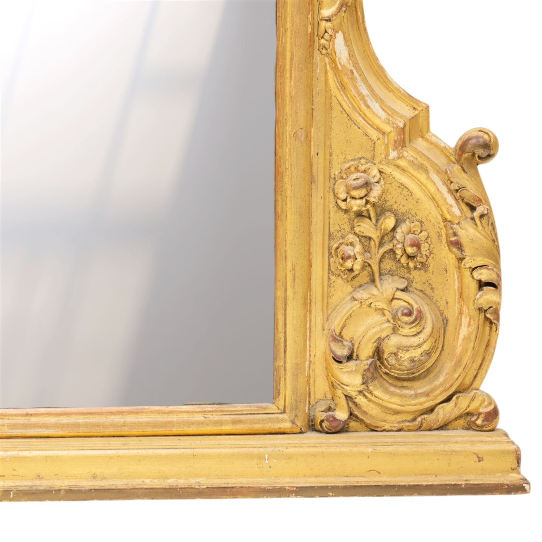 19th century Italian Baroque Revival carved giltwood and gesso wall mirror, the large acanthus leaf pediment flanked by C-scrolls and further acanthi motifs, enclosing a shaped arch plate with moulded slip, flanked by down-scrolls of acanthi with emerging flowering branches, on a stepped base
