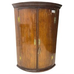 George III oak and mahogany wall hanging cylinder corner cupboard, moulded cavetto cornice over double cupboard enclosing three shelves