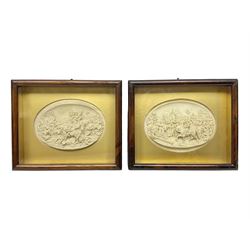 Justin Mathieu, two oval high relief plaque depicting a battle scenes, each within a wooden frame, frame  H21cm, L25cm