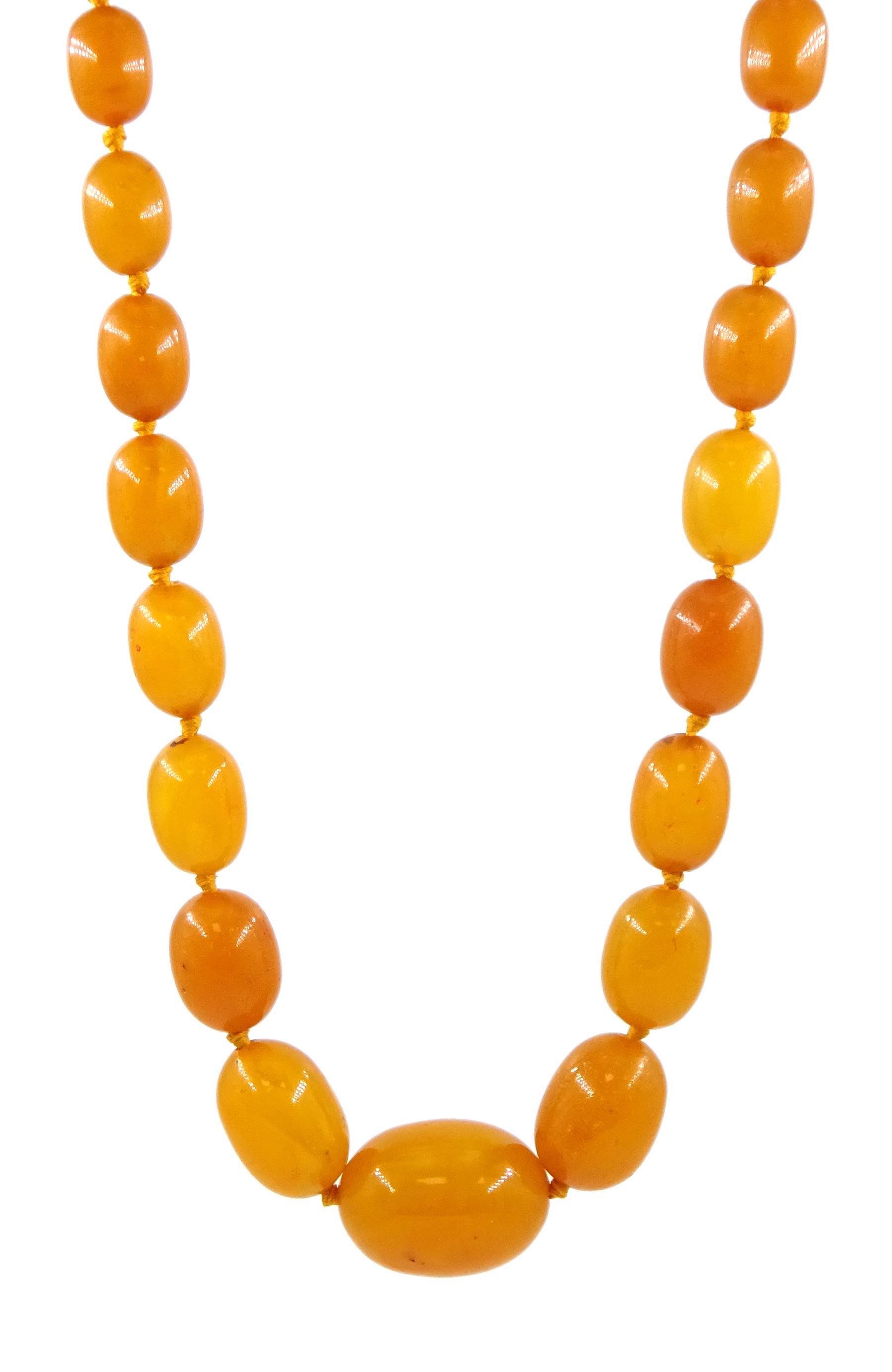 Single strand graduating oval butterscotch amber bead necklace, with three additional loose amber beads