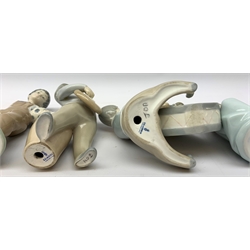  A group of Lladro and Nao figurines, comprising a trio modelled as boys playing instruments, boy with dog, boy with football, girl with puppy and kitten and a goose, (two a/f), all with printed mark beneath.   