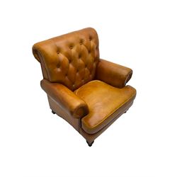 Chesterfield design armchair, upholstered in buttoned tan leather with studwork, on turned feet