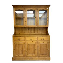Sterling Interiors - traditional pine kitchen dresser, the rack fitted with three glazed doors enclosing single shelf, the base with three drawers over three panelled cupboard doors, on plinth base