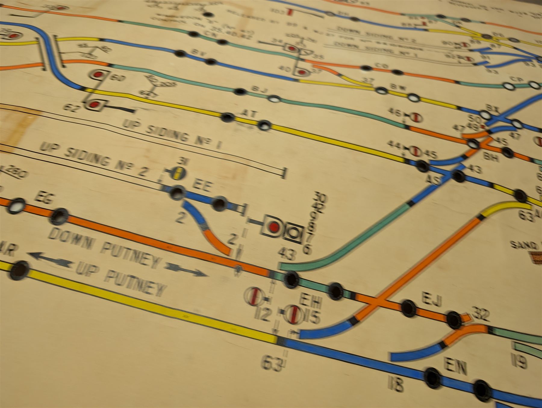 Collection of railway signal maps and similar, including a Wimbledon example, approx 350cm long, together with a collection of book pages depicting images of locomotives