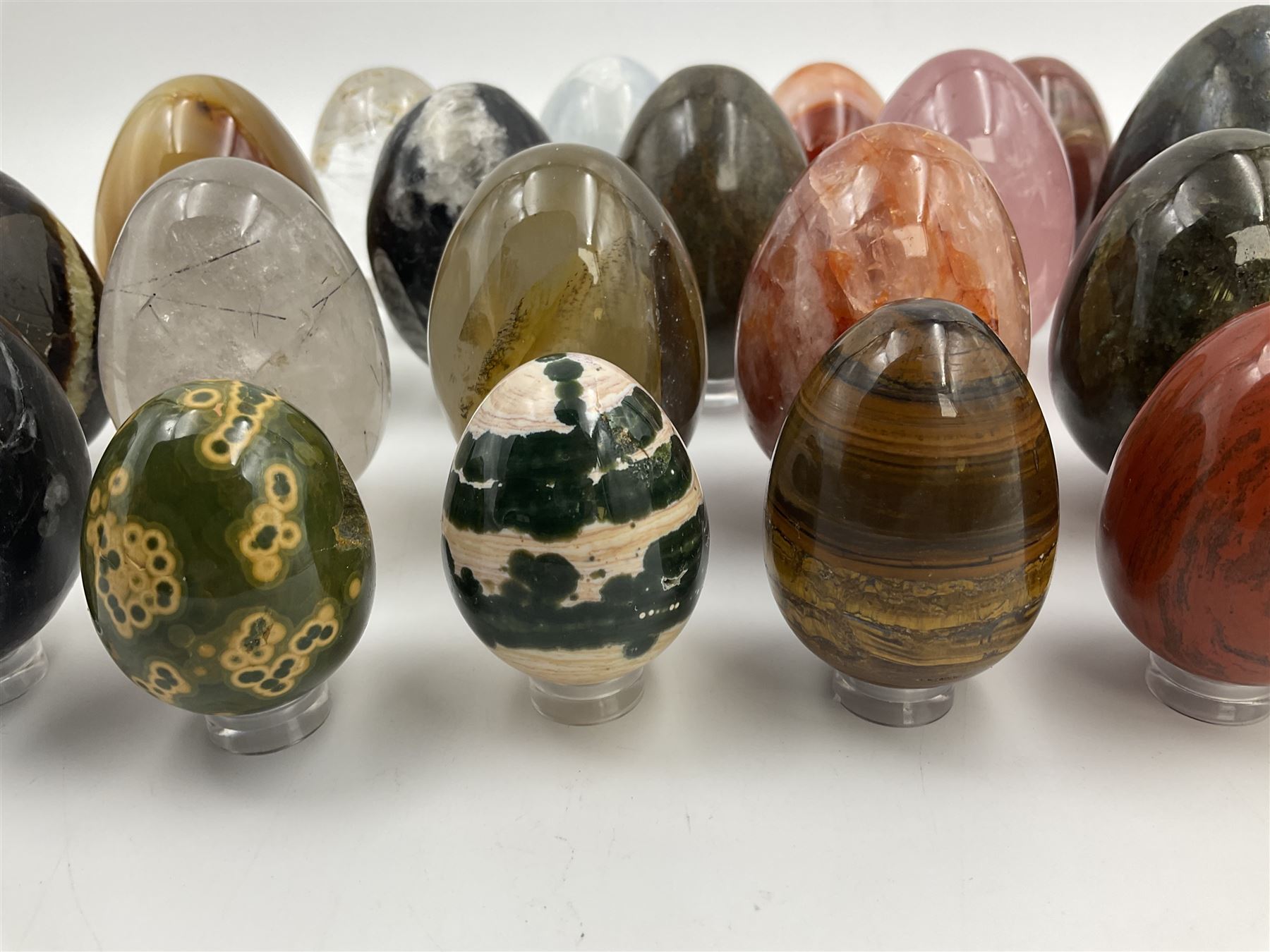 Collection of twenty-one hardstone specimen eggs, including labradorite, calcite, orbicular jasper, tiger's eye, smokey quartz, fossilised wood etc, originally part of the collection of the late Stanley J Seeger