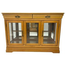 Yew wood sideboard, rectangular top with mahogany and ebony stringing, fitted with two drawers over three glazed cupboard doors enclosing glass shelves
