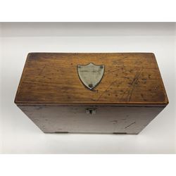 Wooden table stationery box, with drop down front and fitted interior, with metal shield plaque to the hinged lid, H18cm