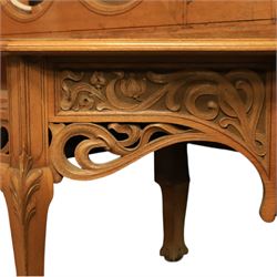 Art Nouveau oak hall mirror, the scrolling frame with large central bevelled mirror plate, boardered by six small mirrors with four shelves between, the base, with carved and pierced floral decoration, upon six cabriole legs   