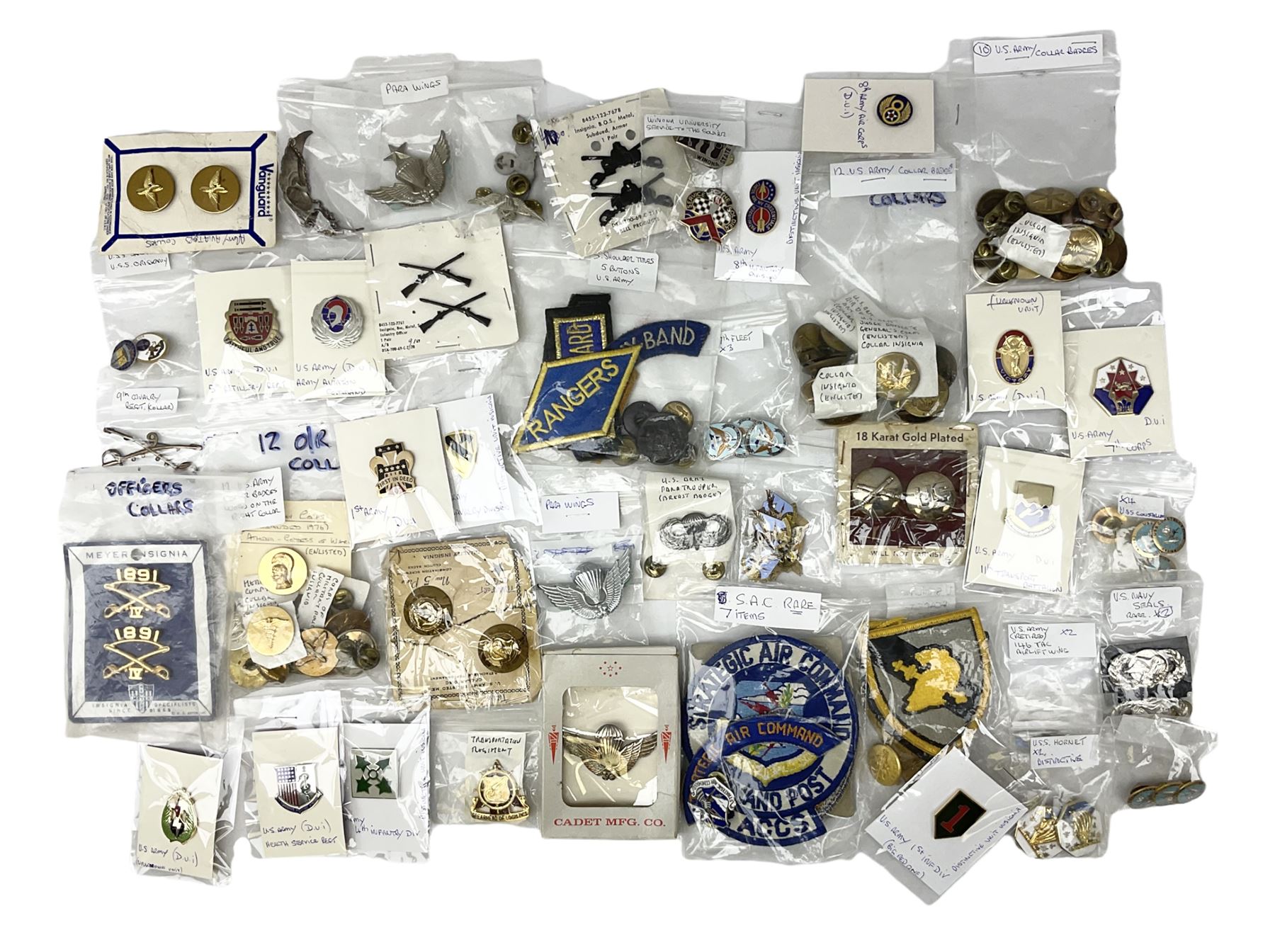 American patches and badges, including para wings, USS Constellation, Strategic Air Command, U.S. military academy, health service regt, Navy Seals, Air Defence Command, Seventh Fleet, various collar badges etc