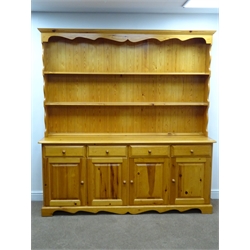 Pine farmhouse dresser, two tier plate rack above four drawers and cupboards, shaped plinth base, W193cm, H203cm, D43cm