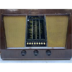 1950 Bush Type PB22 valve radio with Bakelite knobs and central glass tapering panel between with gilt metal mesh speakers, W58cm H42cm D24cm, together with Cossor floor standing radio in walnut veneer case and a Globetrotter radio of Art Deco style with Bakelite knobs and mirrored central panel, H50cm (3)