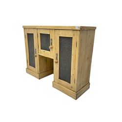Pine kitchen hutch cupboard, enclosed by three doors with metal grilles, on plinth base