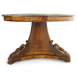 French mid-19th-century Second-Empire mahogany centre table with a dished grey-veined marble top, on a tapered triform pedestal with anthemion brass mounts above carved recumbent swan figures with delicately refined wings and graceful necks curving backwards, associated with the Empress Josephine, raised on three small platform bases