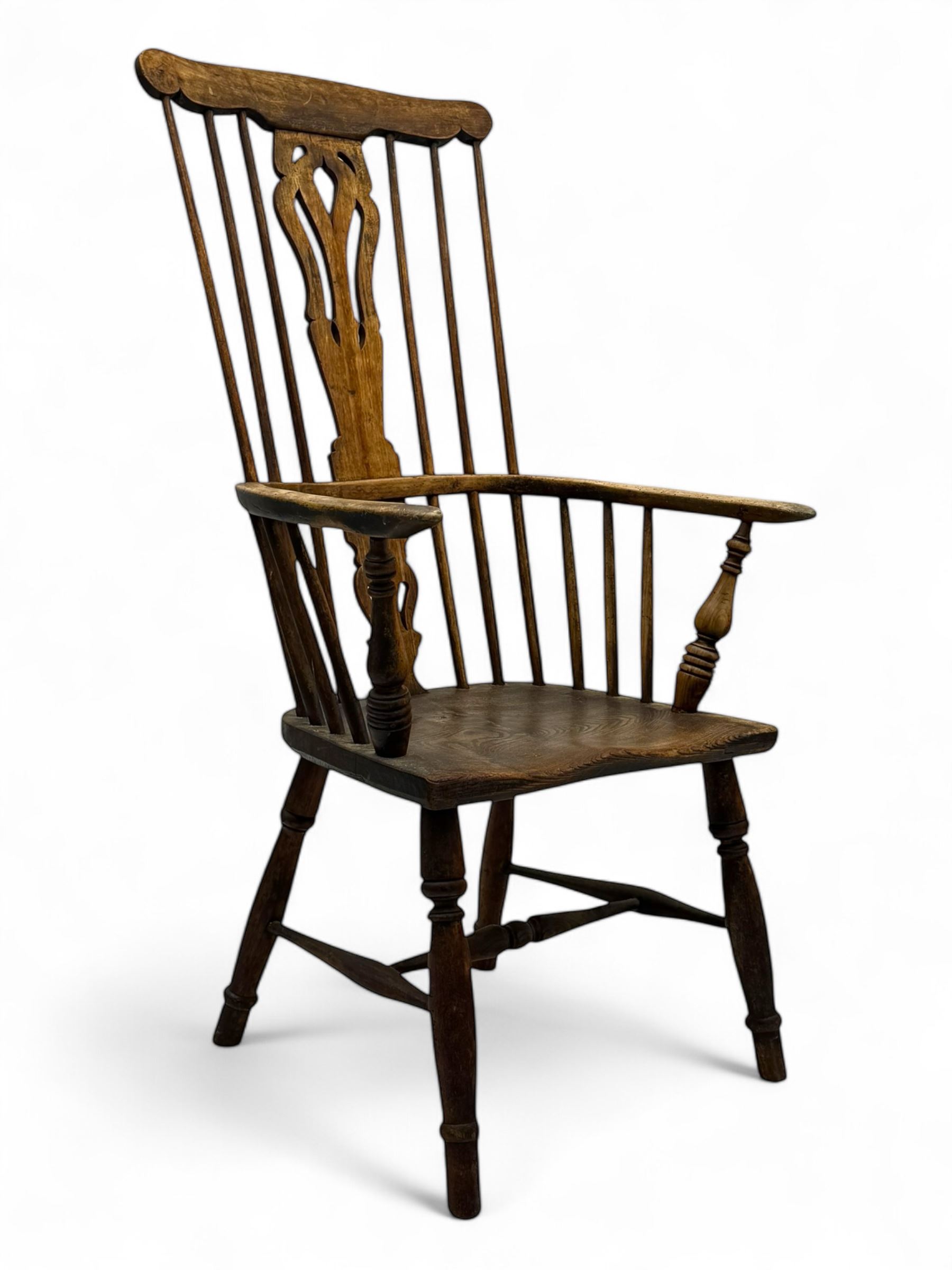 19th century provincial elm and beech Windsor armchair, shaped cresting rail over stick back with pierced and shaped splat, the dished seat on turned supports united by turned stretchers 