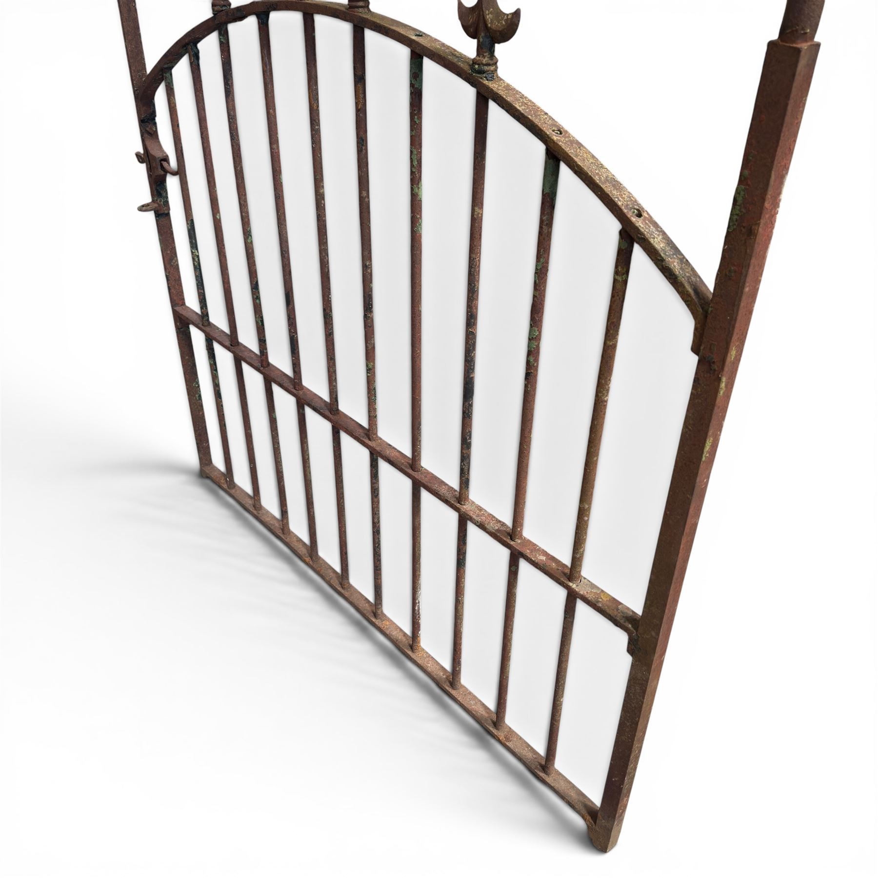 Georgian wrought iron single garden gate, pointed finial over strapwork cresting rail and arched profile with spearhead finials, the opposing side with scrollwork and hinged latch