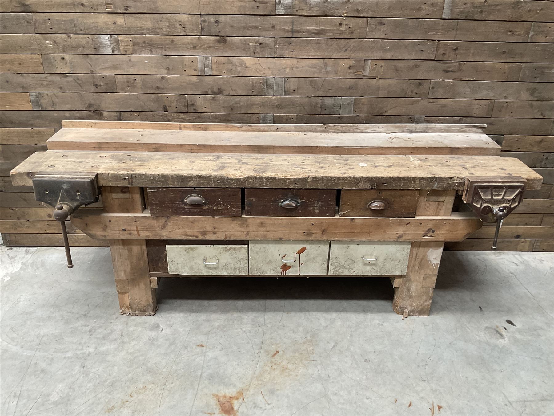 Large vintage work bench, fitted with six drawers and two vice