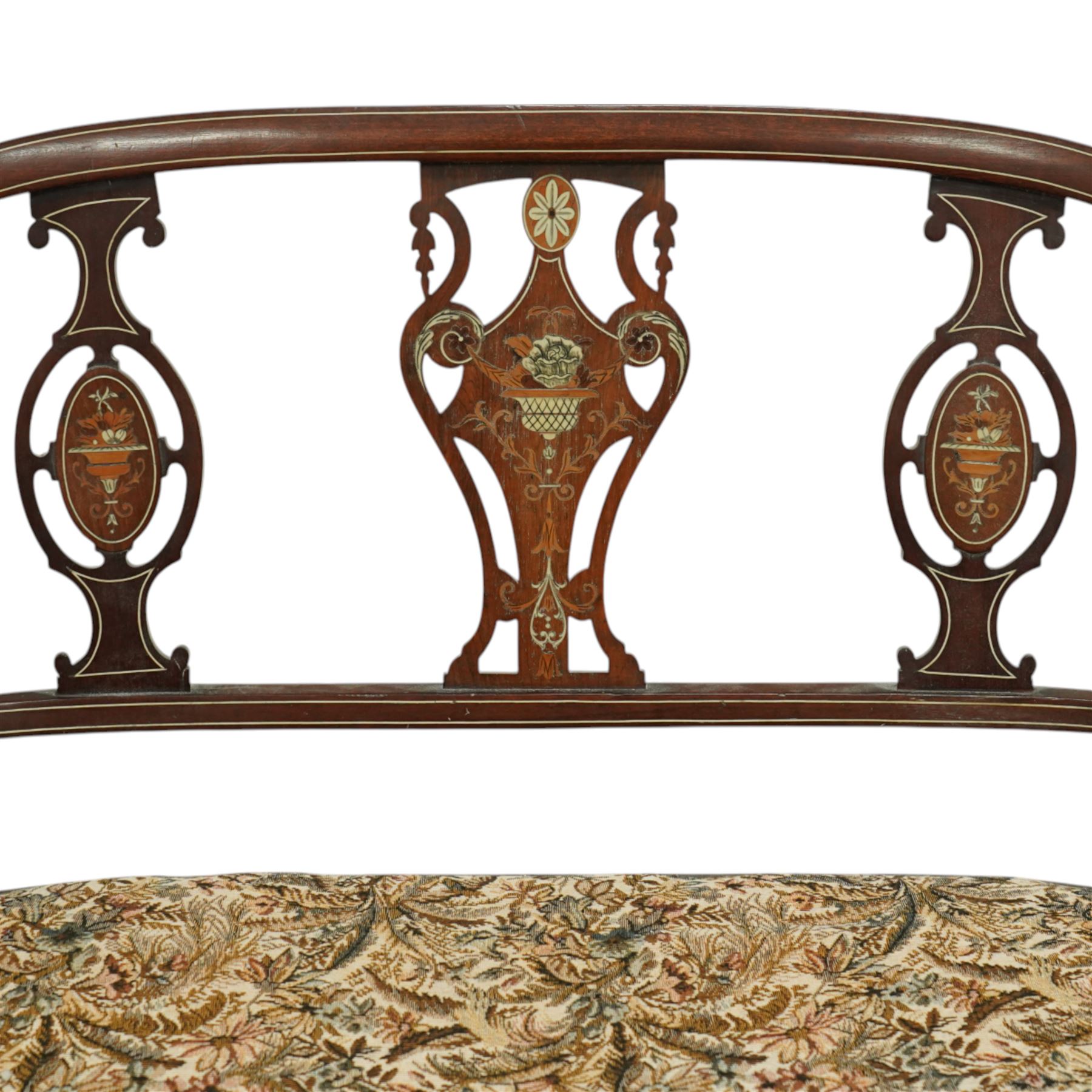 Edwardian marquetry inlaid mahogany salon settee, with bowed top rail and pierced splat back featuring central classical urn flanked by oval floral medallions, floral upholstered seat on boxwood strung square tapering legs terminating in spade feet