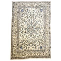 Central Persian Nain hand-knotted carpet, ivory field with central radiating medallion, is...