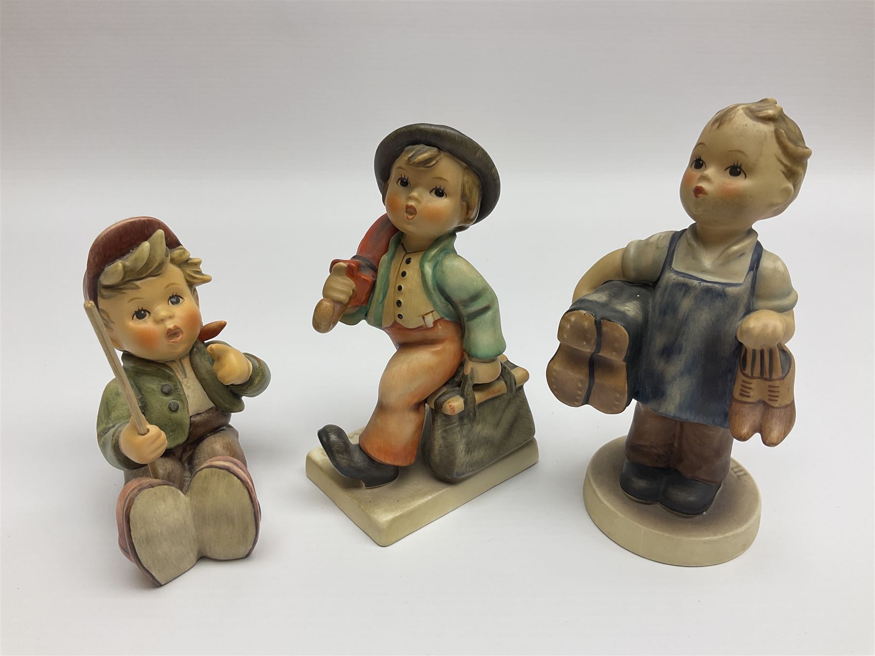 Thirty Hummel figures by Goebel, to include Saluting the Peacekeepers of Operation Joint Endeavor, on wooden plinth, Call to Glory, Celebrate with Song and Soldier Boy