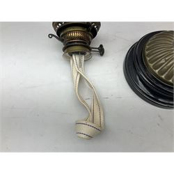 Victorian table oil lamp with black glazed stepped circular base, reeded brass column, moulded pink glass reservoir, duplex burner and frilled rim frosted glass shade with clear glass chimney H69cm