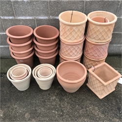  Twenty nine pots comprising of eleven terracotta cylindrical pots with lattice design (maximum D35cm) eight terracotta stackable flower pots (D34cm, H31cm) and a quantity of other pots   