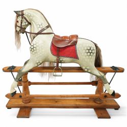 Frederick Henry Ayres (F H Ayres, London) - Late Victorian large carved wooden rocking horse, in dapple grey paint finish, decorated with glass eyes, leather reins, stirrup and saddle, indented hooves, on rockers united by chamfered stretchers and boarded base, c.1890