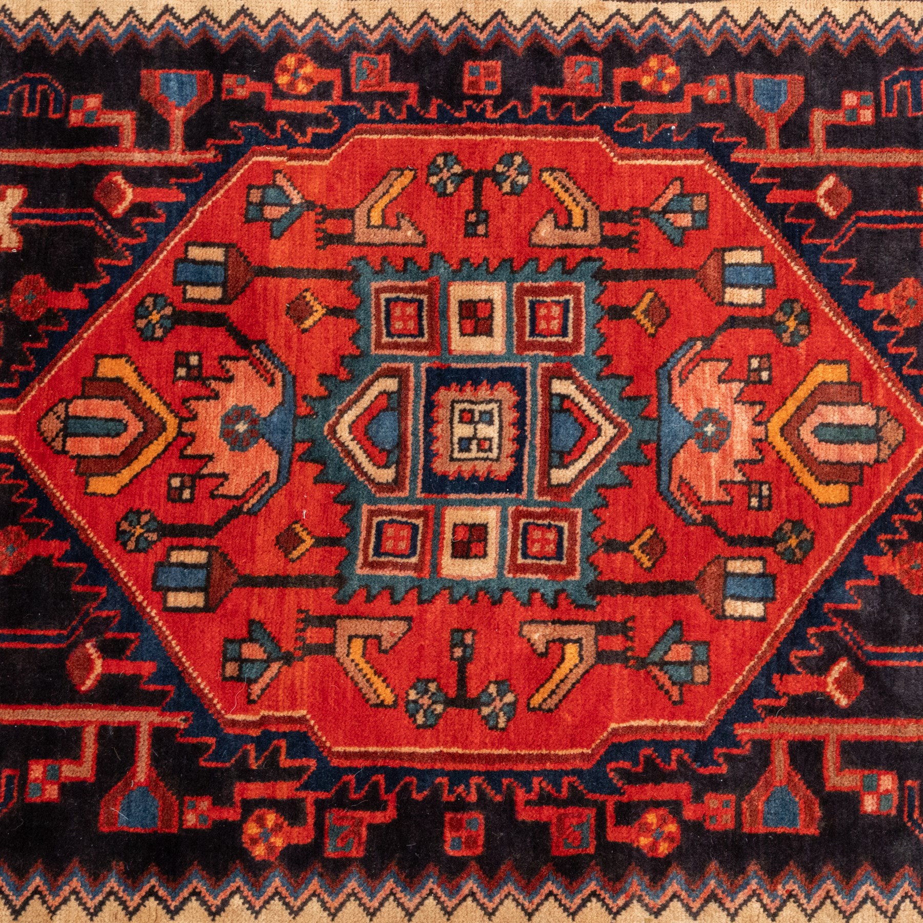 North West Persian runner, the indigo field centred by a red elongated hexagonal medallion with pendant motifs, surrounded by angular flowering stems, ivory stepped floral spandrels, enclosed by an indigo palmette border and red floral guard bands
