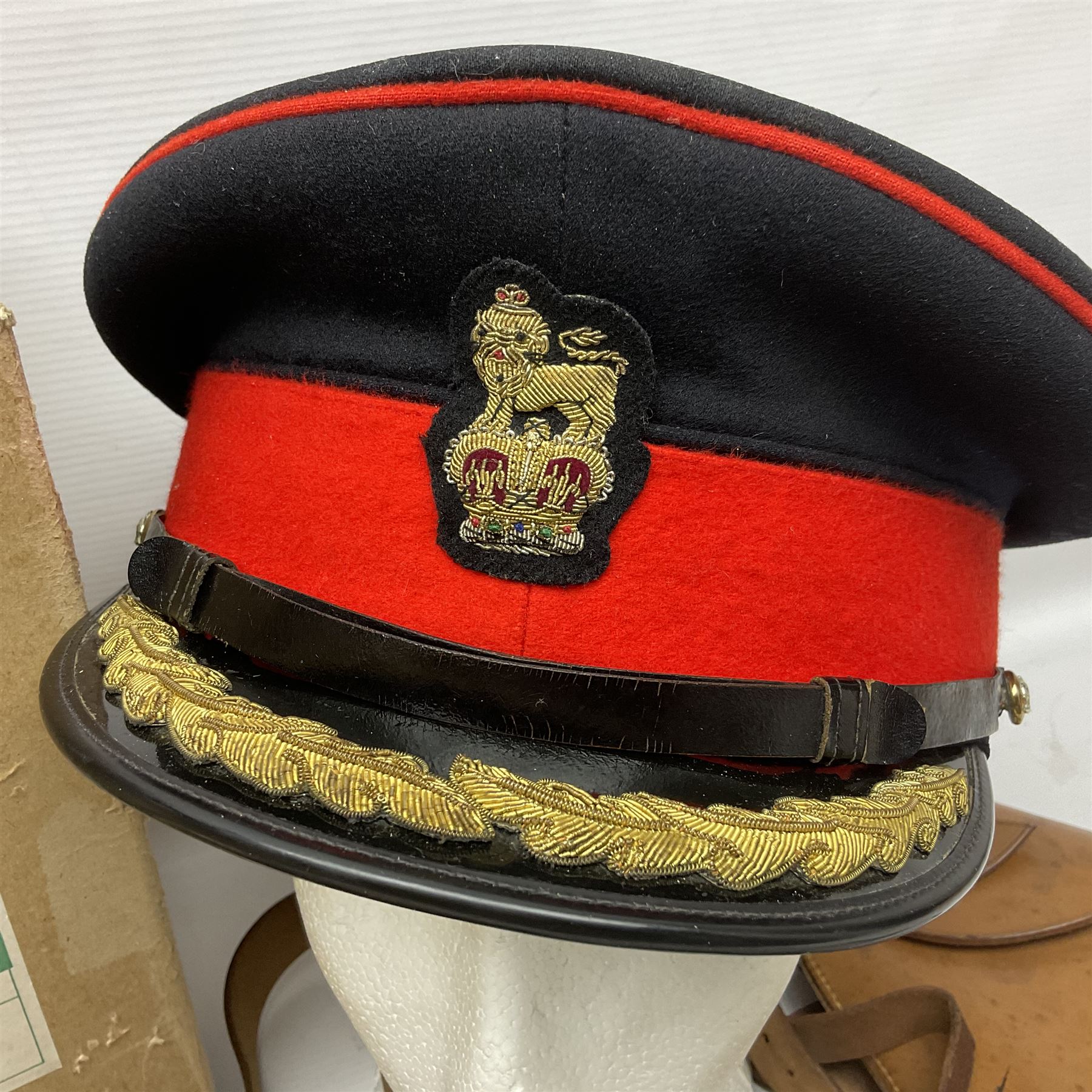 British Army General Staff officer's peaked cap by Herbert Johnson London in Moss Bros. delivery box; two officer's Sam Browne leather belts; leather pistol holster and sword hanger; pair of leather gloves and pair of spurs