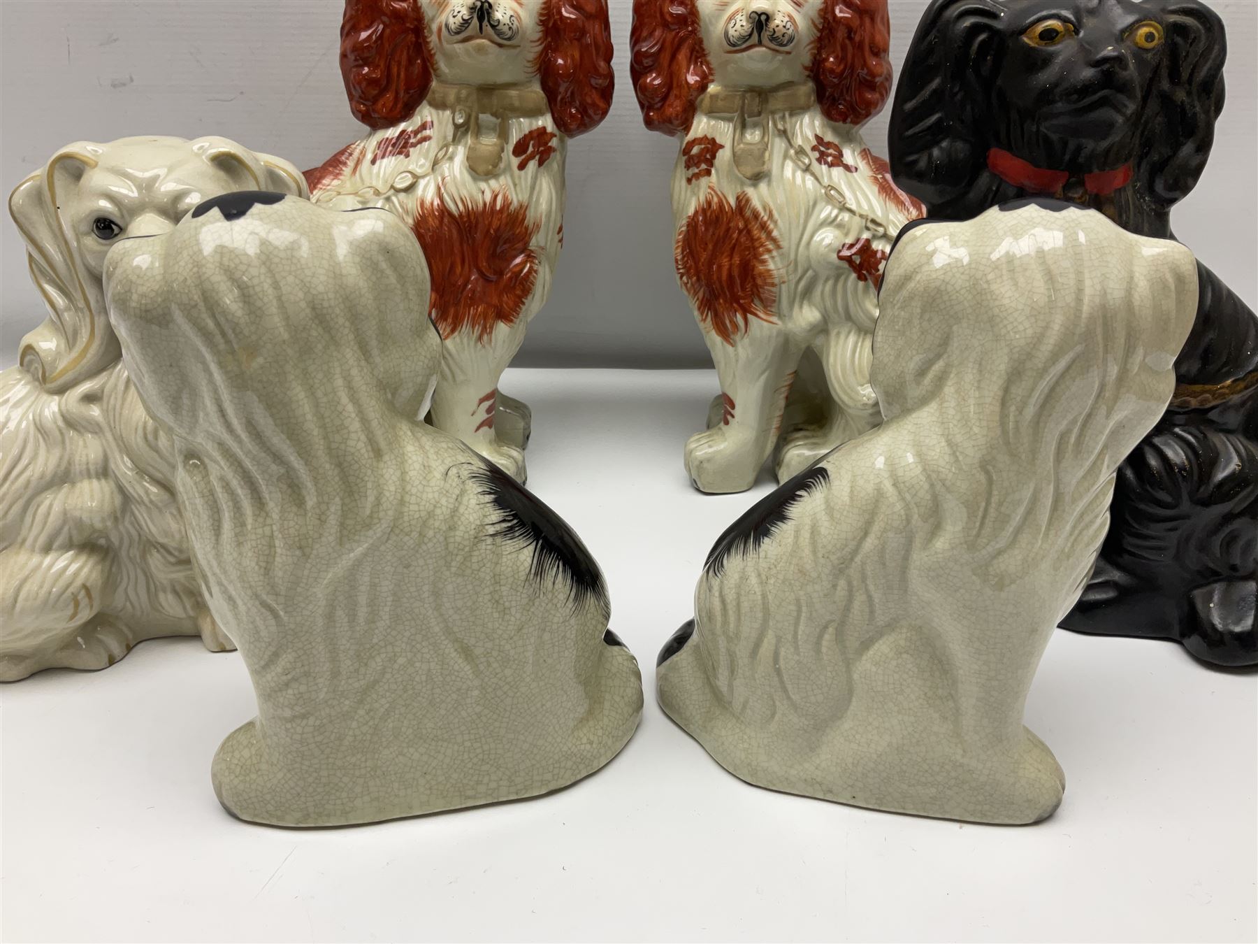 Two Pairs of Staffordshire style dogs, together with three other examples, largest example H27cm