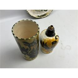 20th century Celtic Pottery, Newlyn, table lamp of tapering form, cylindrical vase and shallow bowl, all decorated with a dark stylised phoenix, modelled with wings outstretched upon sponged ochre, blue and cream ground, bowl D26cm