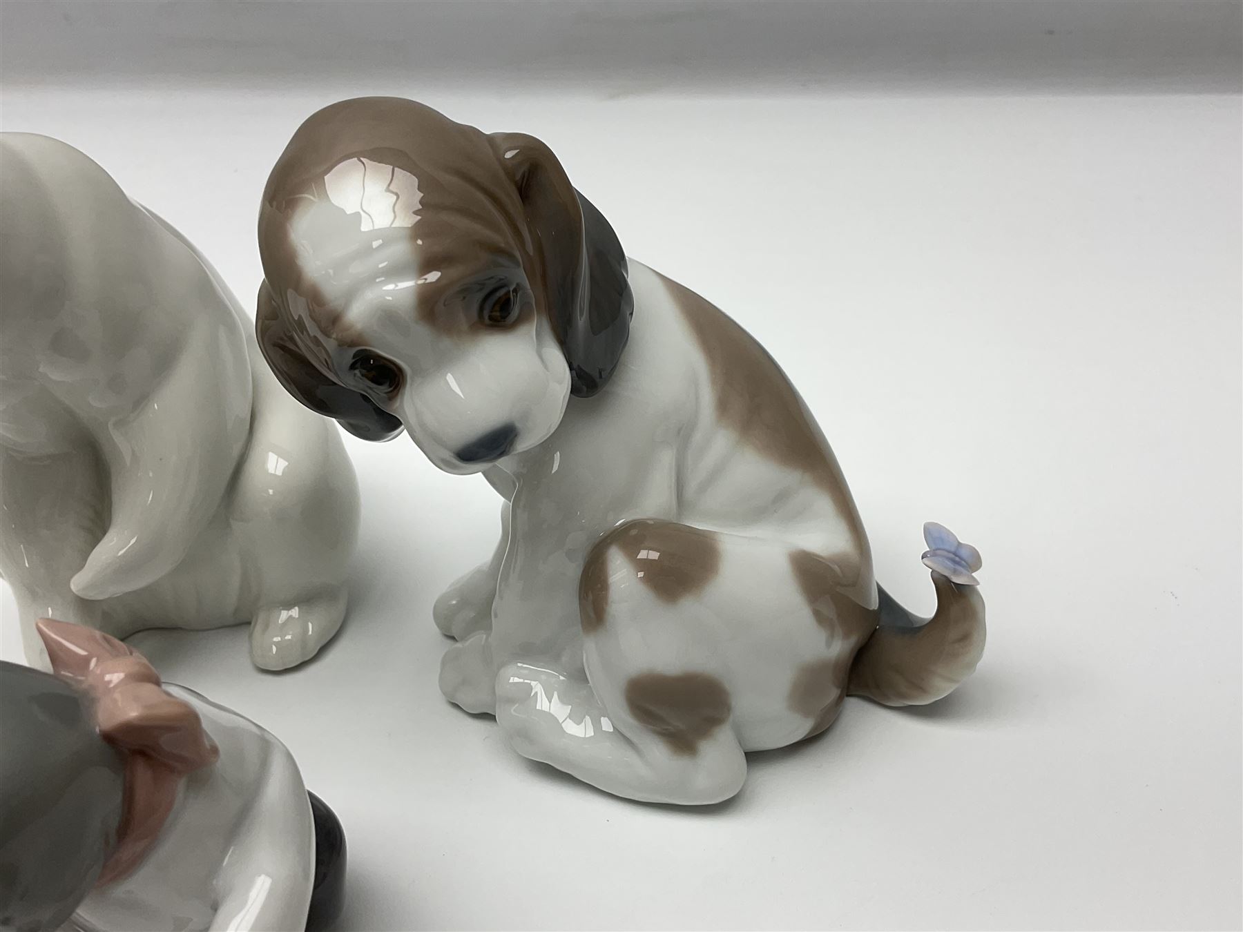 Five Lladro figures, comprising Cat and Mouse no. 5236, That Tickles no. 5888, Gentle Surprise no. 6210, Little Hunter no. 6212 and Resting Polar Bear no. 1208, largest H12cm