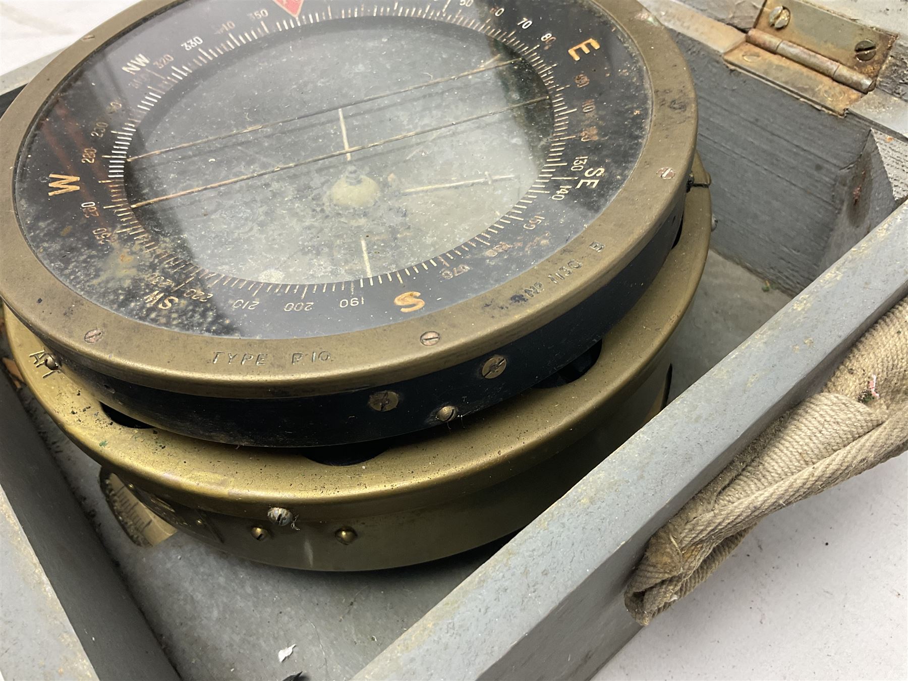  WWII period Type P10 aircraft compass, 16.5cm diameter brass rim marked “Type P10” and “No 1130B”, spring mounted onto brass base with Air Ministry plate marked “Crown A.M. No 6A.1671”; in original grey painted wooden box