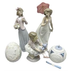 Three Lladro figures, Innocence in Bloom no 7644, Afternoon Promenade no 7636 and Best Friend no 7620, Lladro Christmas ball no 1603 and Lladro easter eggs 1994 no 17532, all with original boxes, largest example H25cm 