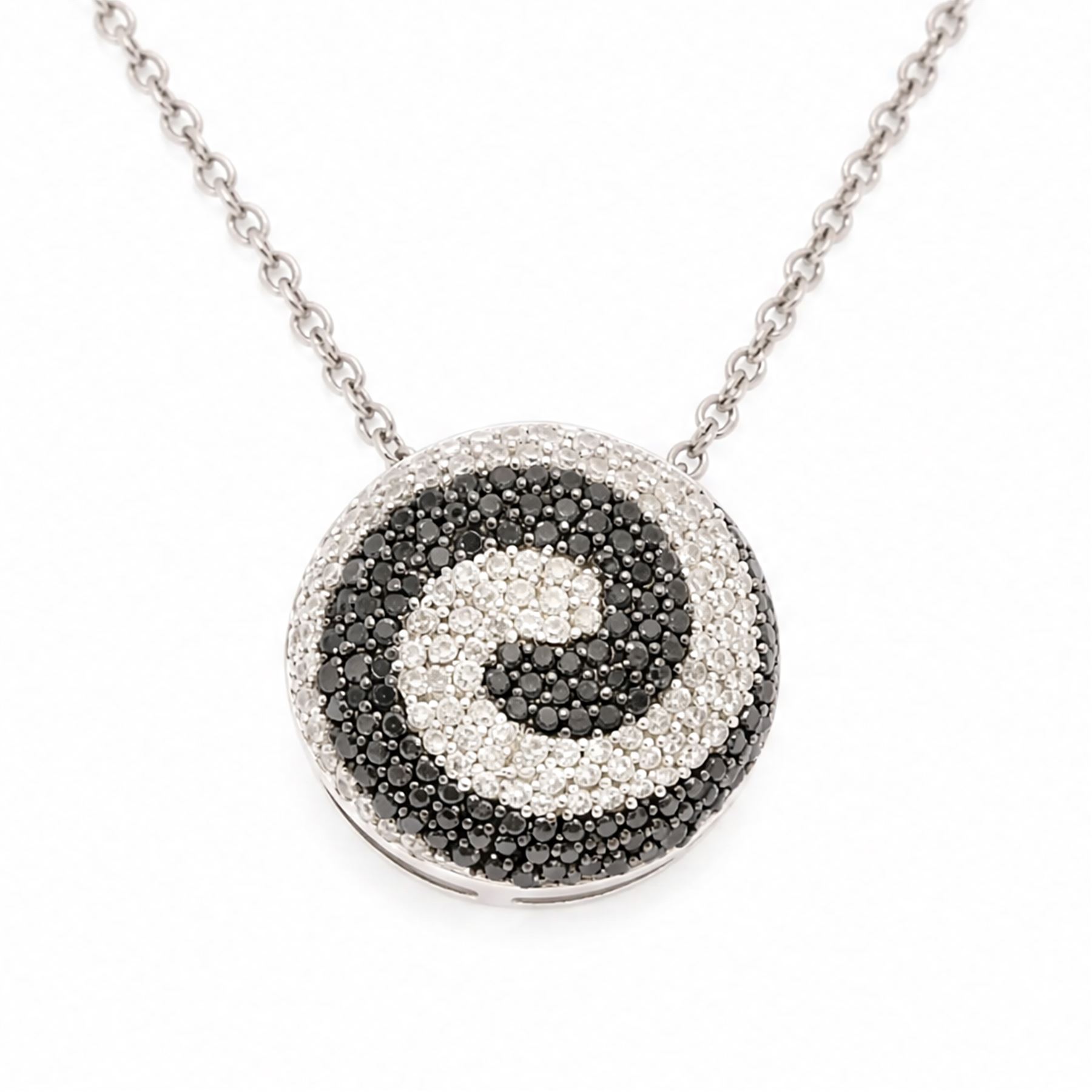 9ct white gold diamond swirl pendant necklace, circular pendant pave set with black and white diamonds, on a fine trace link chain necklace, both hallmarked, total diamond weight approx 1.55 carat