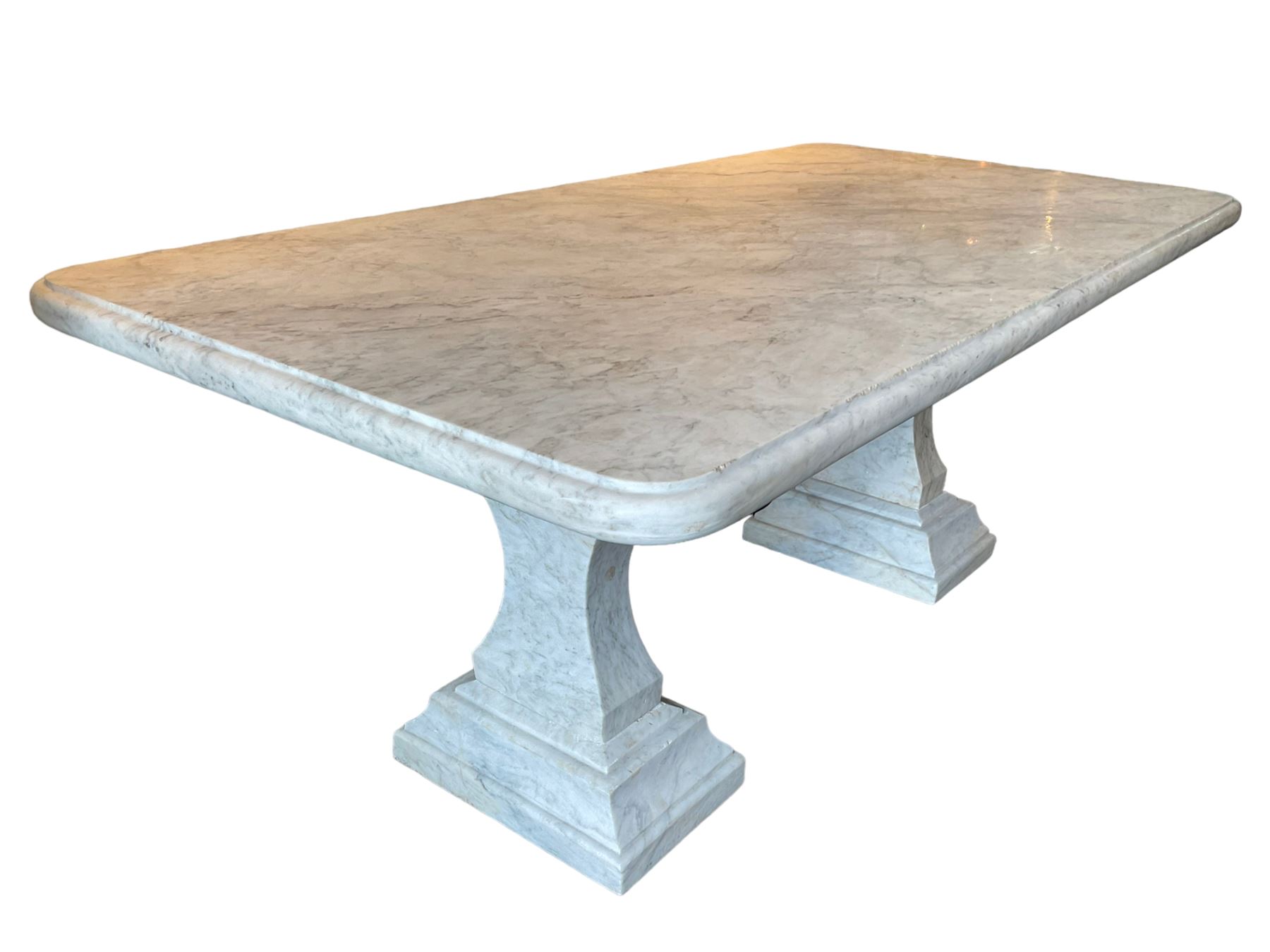 Classical Grecian design Carrera marble centre table, the rectangular single slab top with rounded corners and carved edge, raised on twin pedestals comprised of three pieces with a waisted column on a stepped plinth