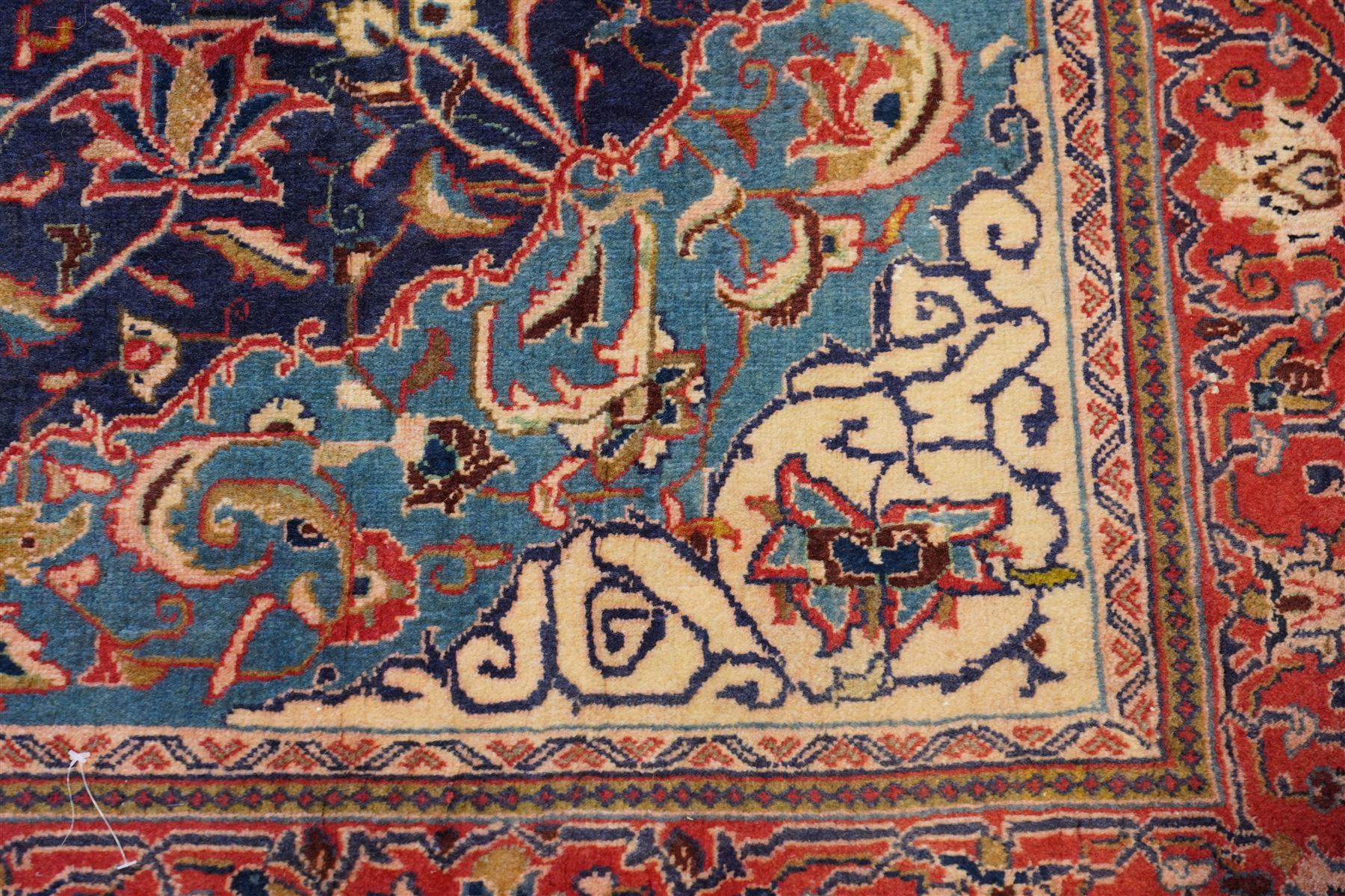 North West Persian Sarouk hand-knotted rug, indigo field with central stepped medallion with pendants, issuing an all-over arrangement of scrolling vinery, palmettes and stylized floral sprays, enclosed by a broad turquoise field of sinuous arabesques,, ivory spandrels with foliate decoration, madder red main border of stylized palmettes, and flowering vines, flanked by reciprocal guard stripes, cotton fringe ends 