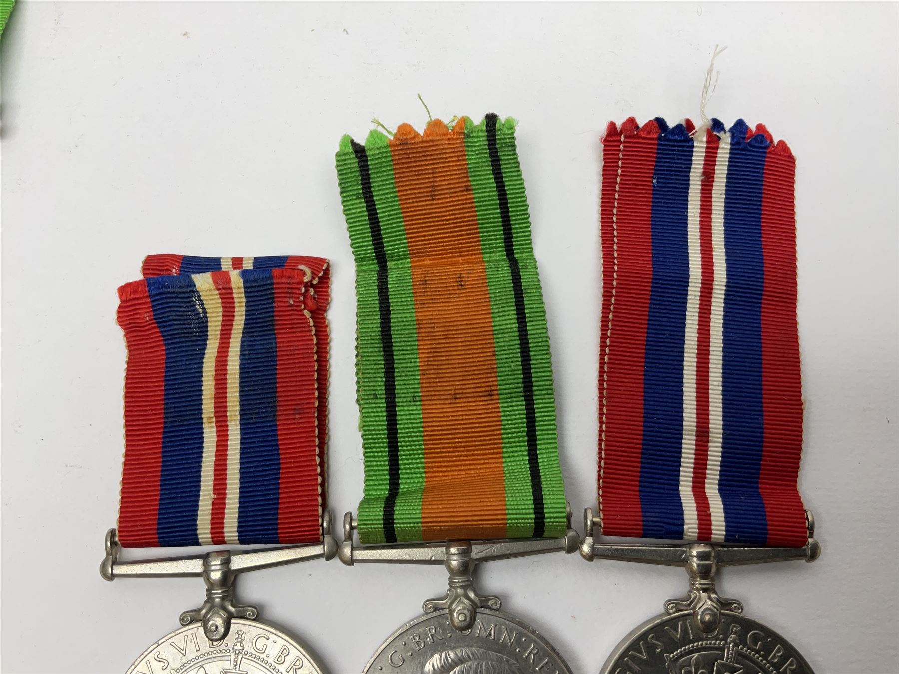 Twelve WW2 medals comprising four 1939-1945 war medals, four Defence medals, three 1939-1945 Stars and Africa Star; all with ribbons; some as groups in two issue boxes with slips