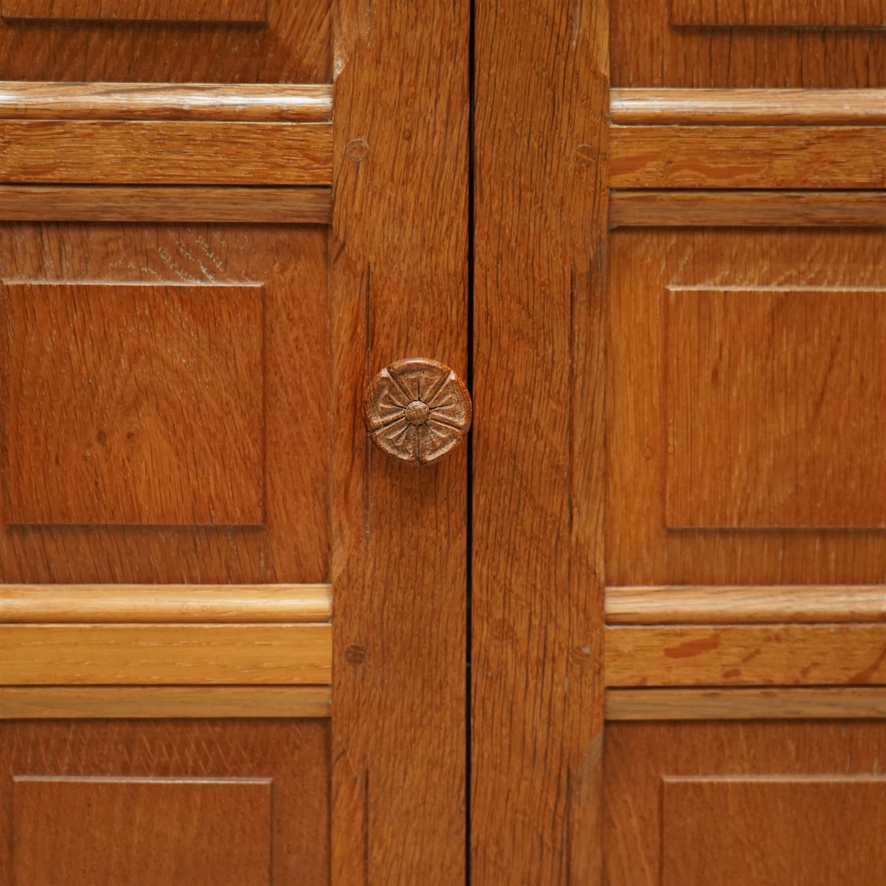  Beaverman - oak media cabinet, rectangular top with interictally carved panels to the side and front doors, twin doors with Yorkshire Rose carved wooden knob, enclosing a staggered shelf arrangement above two drawers, raised on a moulded plinth base, with carved beaver signature, by Colin Almack of Sutton near Thirsk