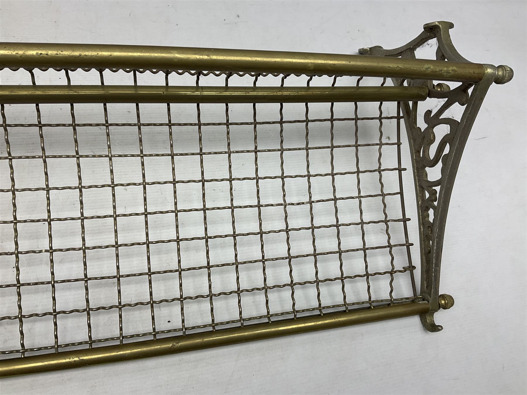 Railway interest - carriage compartment style wall mounting brass and mesh luggage rack, the ends cast with the initials NSWR (New South Wales Railroad) L77cm