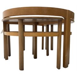 Mid-20th century teak nest of tables, circular coffee table with inset glass top with three elliptical  nesting table 