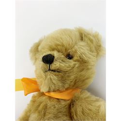 Chad Valley Hygienic Toys teddy bear c1950, kapok filled mohair plush body with original factory given yellow neck ribbon, jointed limbs with velvet paw pads, glass eyes and vertically stitched nose and mouth, blue/white printed label to side seam H12