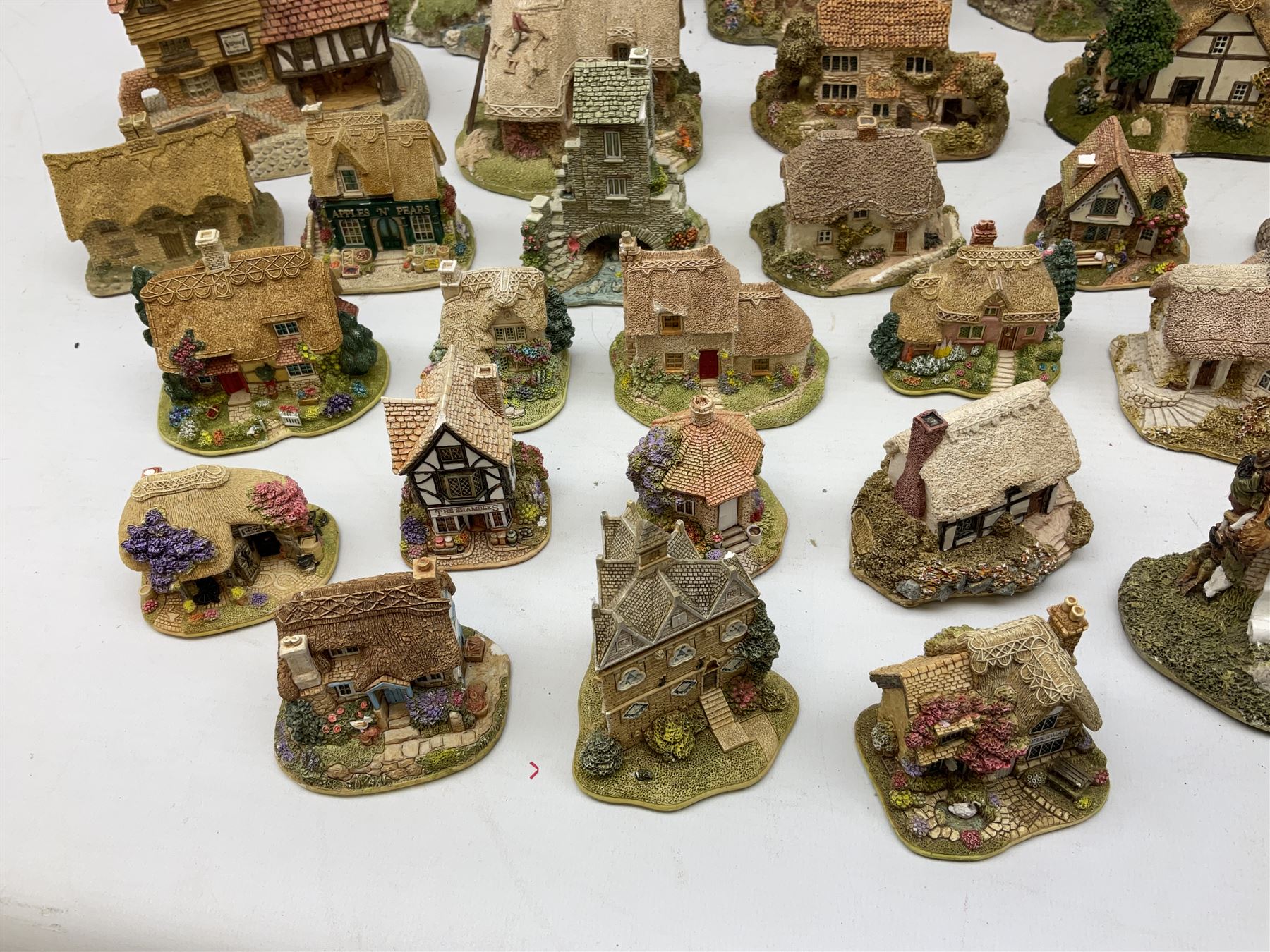 Forty six Lilliput Lane model cottages, to include 'Convent in the Woods', 'Holme Dyke' 'Secret Garden' etc