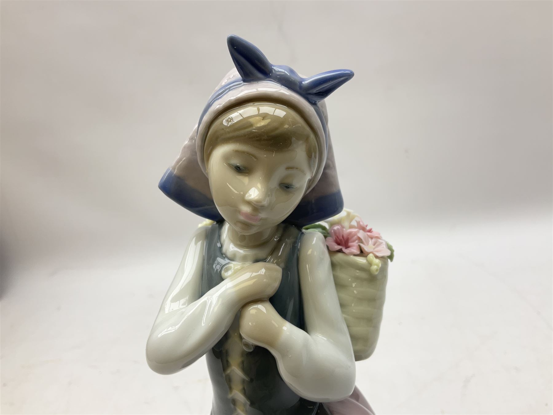 Three Lladro figures, comprising Pondering, no 5173, Nostalgia, no 5071 and Nature's Bounty, no 1417, all with original boxes, largest example H27cm