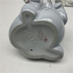 Two Lladro figures, Over the Threshold no 5282 and Prayful Moment no 5500 together with five Nao figures